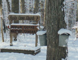 sign pointing directions to Sugar Grove and the Church